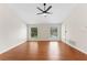 Open bedroom with wood floors, natural light, and a view of the backyard pool at 1591 Chestnut W Ct, Palm Harbor, FL 34683