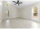 Bright, spacious bedroom with tile floors and a modern ceiling fan at 1591 Chestnut W Ct, Palm Harbor, FL 34683