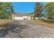 Spacious three car garage showing brick paved driveway at 1591 Chestnut W Ct, Palm Harbor, FL 34683