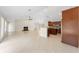 Open-concept great room with kitchen, tile flooring, high ceilings, neutral tones, fireplace, and natural light at 1591 Chestnut W Ct, Palm Harbor, FL 34683