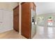 Kitchen features stainless steel refrigerator, and pantry in a light and airy kitchen at 1591 Chestnut W Ct, Palm Harbor, FL 34683