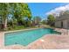 Refreshing swimming pool with a brick-paved patio and landscaped backyard at 1591 Chestnut W Ct, Palm Harbor, FL 34683
