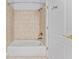 Full bathroom with shower and tan-colored tile at 1591 Chestnut W Ct, Palm Harbor, FL 34683