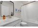 Well-lit bathroom showcasing white vanity, toilet, and shower-tub with neutral finishes at 17923 Cantarina Cv, Bradenton, FL 34211