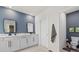 Modern bathroom features double sinks, marble countertops, and stylish fixtures at 17923 Cantarina Cv, Bradenton, FL 34211