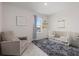 Serene Bedroom features a cozy armchair, crib, and soft rug at 17923 Cantarina Cv, Bradenton, FL 34211