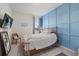 Charming bedroom features soft blue tones, a decorative accent wall, and comfortable furnishings at 17923 Cantarina Cv, Bradenton, FL 34211