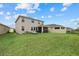 Expansive backyard features lush lawn, patio and lounge chairs, perfect for relaxation and outdoor enjoyment at 17923 Cantarina Cv, Bradenton, FL 34211