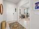 Bright foyer featuring tile flooring, a round mirror, and a decorative rug that adds character to the space at 17923 Cantarina Cv, Bradenton, FL 34211