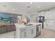 Open-concept kitchen with a large island, stainless steel appliances, and a seamless transition into the living room at 17923 Cantarina Cv, Bradenton, FL 34211
