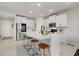 Modern kitchen features stainless steel appliances, a large island, and sleek white cabinetry at 17923 Cantarina Cv, Bradenton, FL 34211