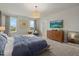 Bright and airy main bedroom featuring large windows, a wooden dresser, and neutral decor at 17923 Cantarina Cv, Bradenton, FL 34211