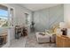 Cozy office with a patterned accent wall, a neutral color scheme, and natural light that creates an inviting work space at 17923 Cantarina Cv, Bradenton, FL 34211
