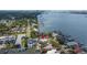 Aerial view of the home, its private dock, pool, and proximity to the open bay waters at 1827 Venetian Point Dr, Clearwater, FL 33755