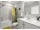 Updated bathroom with marble tile, shower-tub combo, and stylish vanity at 1827 Venetian Point Dr, Clearwater, FL 33755