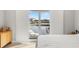 Bedroom with sleek sliding glass doors opening to water view and boat dock at 1827 Venetian Point Dr, Clearwater, FL 33755