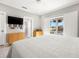 Modern bedroom with water views, TV and neutral color scheme at 1827 Venetian Point Dr, Clearwater, FL 33755
