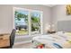 Bright bedroom with a work station and a large window offering a serene neighborhood view at 1827 Venetian Point Dr, Clearwater, FL 33755