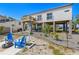 Back exterior of the house featuring outdoor furniture, landscaping, and stylish construction on an elevated foundation at 1827 Venetian Point Dr, Clearwater, FL 33755