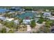 Attractive home with inviting porch, stone walkway, lush trees, and serene waterfront ambiance at 1827 Venetian Point Dr, Clearwater, FL 33755
