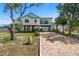 Charming two-story home with a brick driveway and ample outdoor space, perfect for entertaining at 1827 Venetian Point Dr, Clearwater, FL 33755