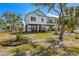Beautifully landscaped home featuring a spacious front yard, perfect for outdoor activities and relaxation at 1827 Venetian Point Dr, Clearwater, FL 33755
