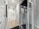 Bright hallway featuring an elevator and access to various rooms at 1827 Venetian Point Dr, Clearwater, FL 33755