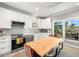 Kitchen with modern appliances, a view through the window, and an adjacent dining table at 1827 Venetian Point Dr, Clearwater, FL 33755