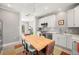 Open-concept kitchen with stainless steel appliances and dining table, leading to the living room at 1827 Venetian Point Dr, Clearwater, FL 33755