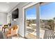 View from the living room of the large deck with table and chairs, overlooking the water at 1827 Venetian Point Dr, Clearwater, FL 33755