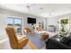 Spacious living room with views of the canal and a leather sofa at 1827 Venetian Point Dr, Clearwater, FL 33755