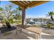 Relax and unwind at the wooden table with views of the waterfront and boat dock at 1827 Venetian Point Dr, Clearwater, FL 33755