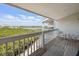 Picturesque condo balcony with seating and views of waterway and surrounding greenery, perfect for enjoying the outdoors at 19727 Gulf Blvd # 207, Indian Shores, FL 33785