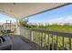 Relaxing condo balcony featuring outdoor seating with scenic views of the surrounding landscape and nearby homes at 19727 Gulf Blvd # 207, Indian Shores, FL 33785