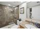 Elegant bathroom with stone-look shower, granite countertops, and modern fixtures at 19727 Gulf Blvd # 207, Indian Shores, FL 33785