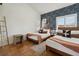 Charming bedroom with two beds, stylish wallpaper, and neutral decor at 19727 Gulf Blvd # 207, Indian Shores, FL 33785