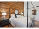 Well-lit bedroom with a four-poster bed and ample natural light at 19727 Gulf Blvd # 207, Indian Shores, FL 33785