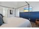 Cozy bedroom featuring a modern four-poster bed and a mounted television at 19727 Gulf Blvd # 207, Indian Shores, FL 33785