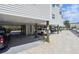 Carport with parking spaces beneath elevated home at 19727 Gulf Blvd # 207, Indian Shores, FL 33785