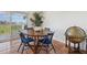 Cozy dining room features a round table, seating for four, and view of the outdoor scenery at 19727 Gulf Blvd # 207, Indian Shores, FL 33785
