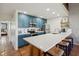 Stylish kitchen featuring blue cabinets, modern appliances, and a spacious island with seating, ideal for entertaining at 19727 Gulf Blvd # 207, Indian Shores, FL 33785
