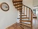 Unique spiral staircase with wood treads and metal accents, adds a touch of nautical charm with a porthole mirror at 19727 Gulf Blvd # 207, Indian Shores, FL 33785