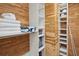 Spacious walk-in closet with custom wood shelving and ample storage space at 19727 Gulf Blvd # 207, Indian Shores, FL 33785