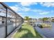 Beautiful waterfront backyard with dock and covered lanai, perfect for outdoor entertaining and enjoying scenic water views at 200 98Th Ne Ave, St Petersburg, FL 33702