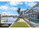 A beautiful outdoor space featuring a private dock, canal view, and a screened-in pool enclosure at 200 98Th Ne Ave, St Petersburg, FL 33702