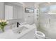 Bright bathroom features stand-up shower with glass door and white marble tile at 200 98Th Ne Ave, St Petersburg, FL 33702