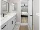 Bright bathroom featuring a modern vanity, updated fixtures, and a doorway view into bedroom at 200 98Th Ne Ave, St Petersburg, FL 33702