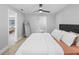 Cozy bedroom features a ceiling fan and modern style with a view into the living room at 200 98Th Ne Ave, St Petersburg, FL 33702