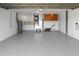 Spacious garage with epoxy flooring, ample storage cabinets, and utility equipment at 200 98Th Ne Ave, St Petersburg, FL 33702
