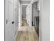 Hallway with luxury vinyl plank flooring leads to laundry room and other rooms at 200 98Th Ne Ave, St Petersburg, FL 33702